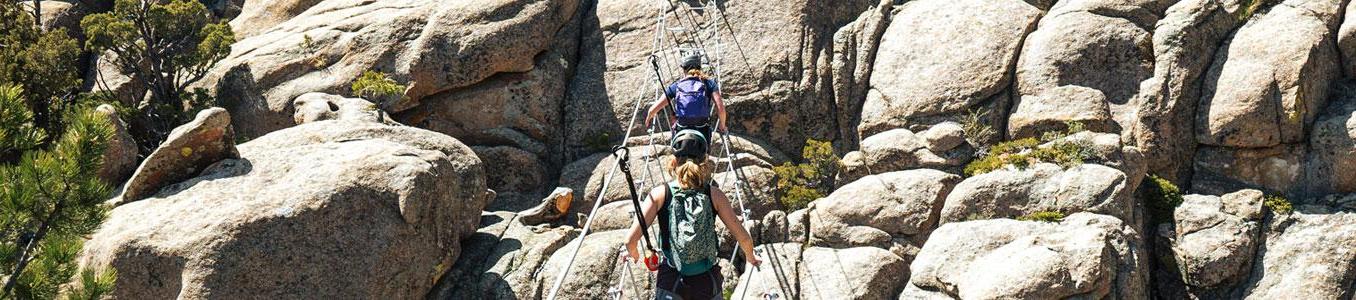 group crossing cable bridge on via ferrata